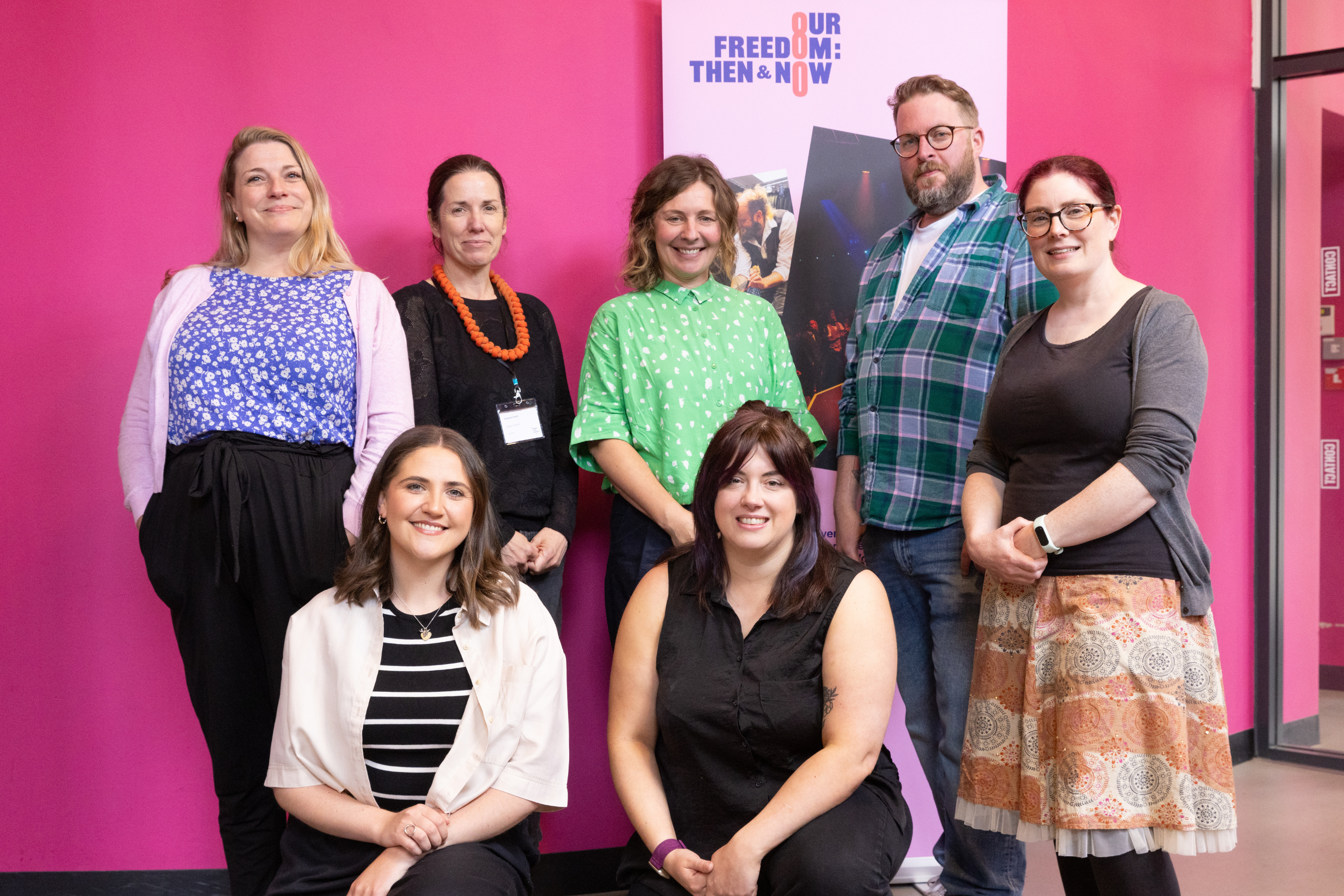 A posed shot of a group of seven people (five standing and two kneeling) - the six Our Freedom Cluster Coordinators, plus Simon Savidge of Libraries Connected.