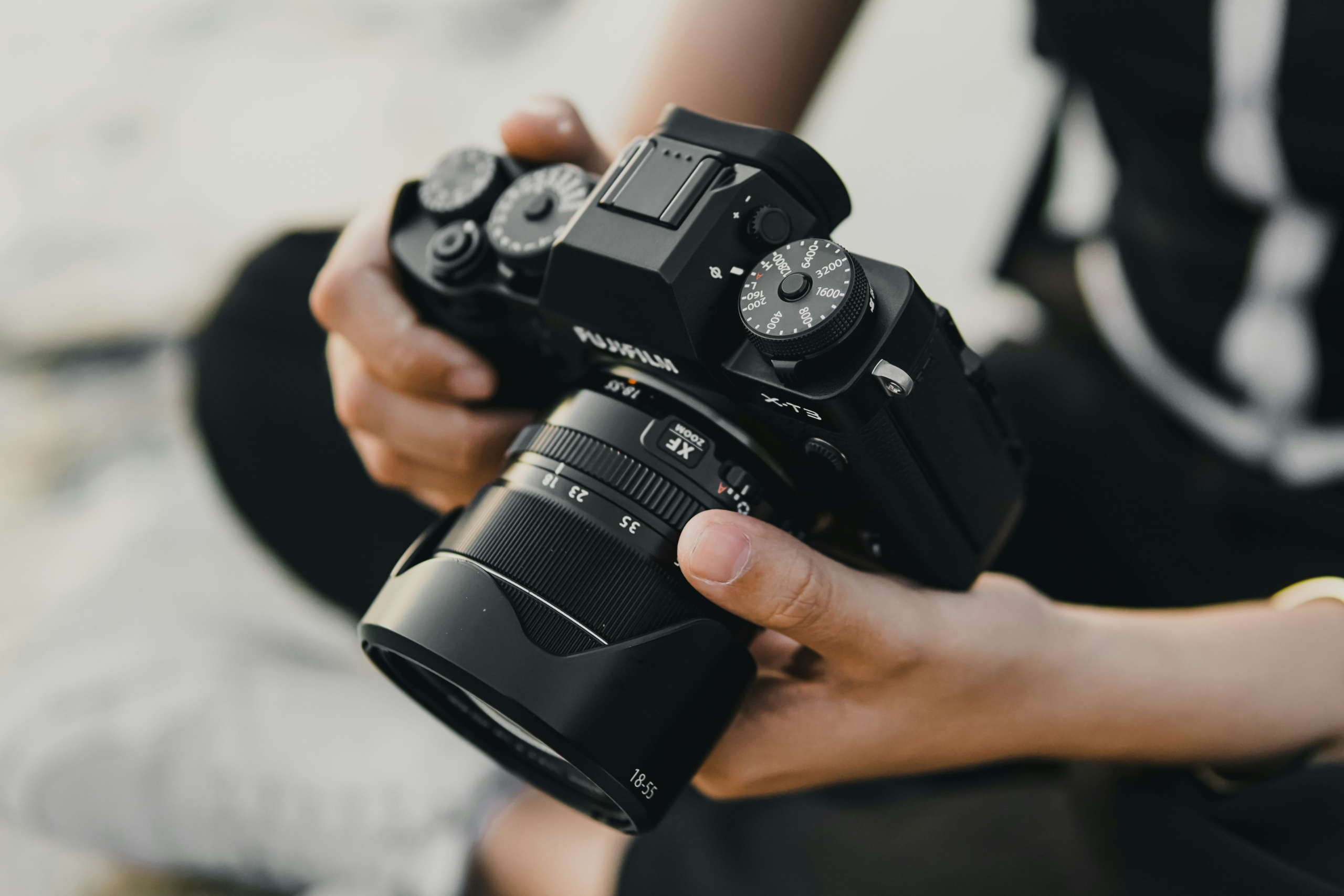 Person (face out of shot) holding a camera