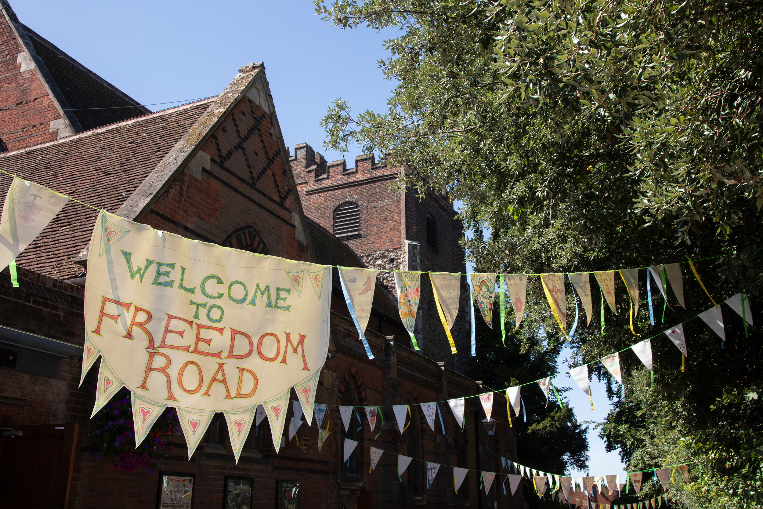 Bunting strung outdoors, with a large panel reading 'Freedom Road'